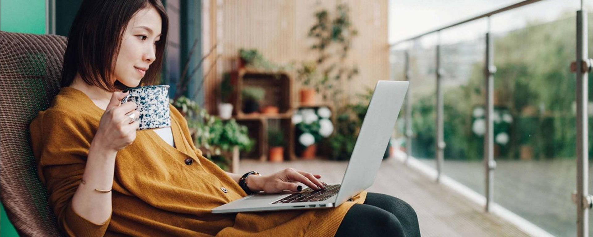Woman on her laptop drinking her morning coffee