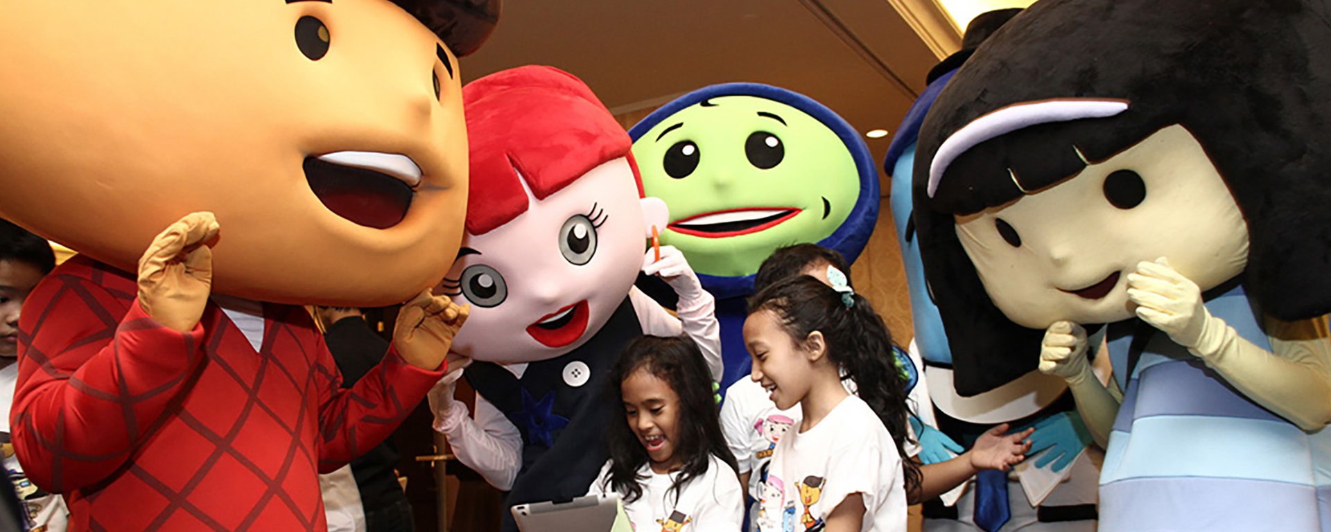 Children reading from a tablet with Cartoon Network characters